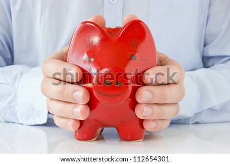 Business man holding piggy bank , concept for money protection