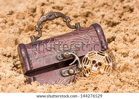 Pirate treasure chest with  the gold  on a sandy beach