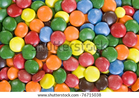 Background image of sweet smarties or chocolate buttons.