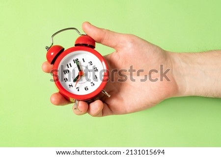 Man holding red  alarm clock. Wake up time. Office working hours.  Сток-фото © 