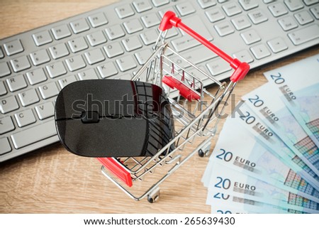 Shopping cart with mouse in front of  keyboard ,online shopping concept