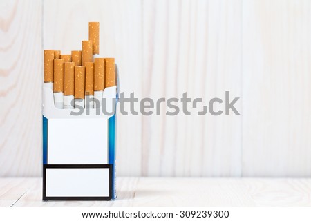 Pack of cigarettes on white wood  background. With copy-space for text