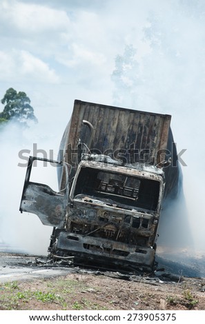 SURATTHANI THAILAND- AUG 17: Police firefighter rescuers helped extinguish a burning tractor trailer trucks horn pure alcohol on Aug 17,2014 in suratthani province,thailand