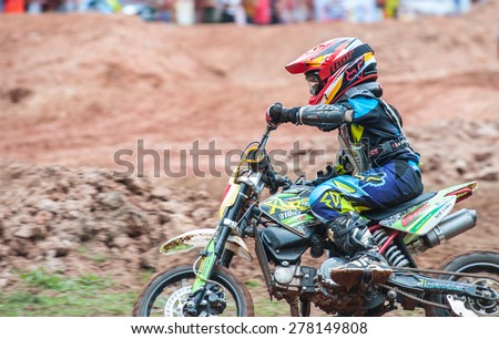 SURAT THANI THAILAND- Jul 20: The motorcross competition for charity and free fee to see .Among crowed of people to cheer up at BanhuoySork School on Jul 20, 2014 in surat thani province,Thailand