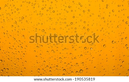 water drops rain on mirror background with orange.