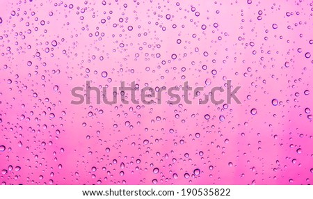 water drops rain on mirror background with pink.