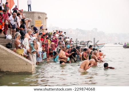 VARANASI, INDIA - OCTOBER 23: Hindu people take a bath in the river ganges on the Dewali festival on October 23, 2014  at ghat in Varanasi, Uttar Pradesh, India. Dewali is festival of lights in India.