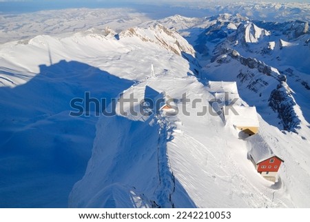Snowed guesthouses and the shadow from the top of Saentis - Kanton of Apenzell, Ausserrhoden, Switzerland, Europe. Stockfoto © 