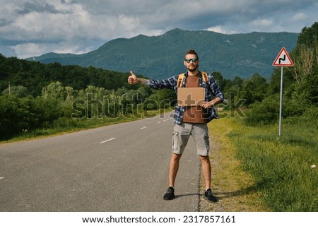 Similar – Image, Stock Photo Pleased tourist with backpack taking selfie on smartphone sitting on bridge above mountain river