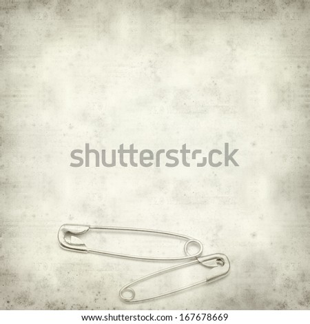 textured old paper background with safety pin