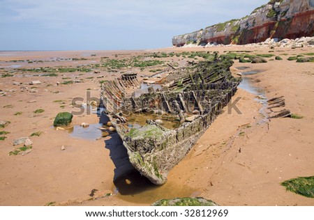 old shipwreck under two-colored cliffs, Hunstanton, Norfolk, Uk