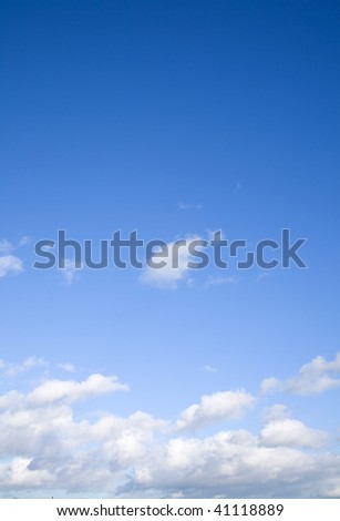 vertical blue sky background with light clouds on the horizon