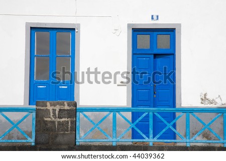 architectural detail - bright blue door and window in a whitewashed wall; old spanish town (Canary islands)