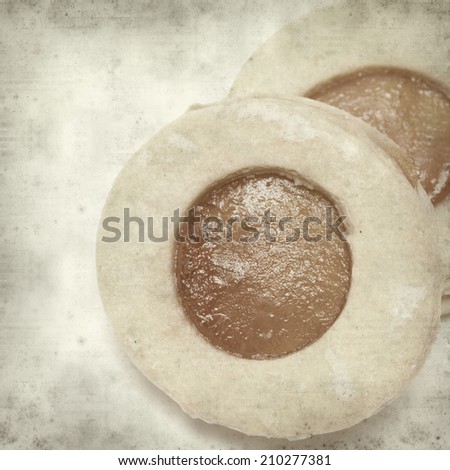 textured old paper background with traditional canarian shortbread with jam