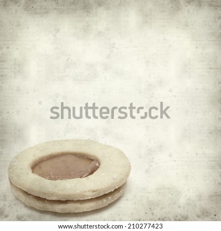 textured old paper background with traditional canarian shortbread with jam