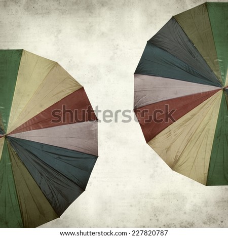 textured old paper background with rainbow umbrella