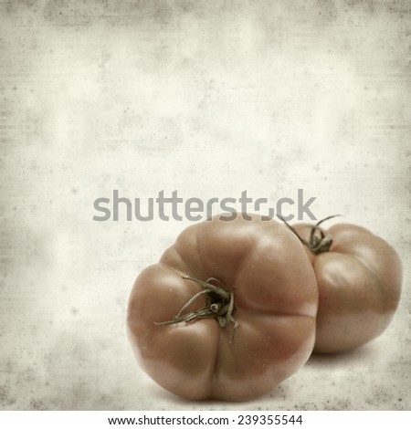 textured old paper background with large red tomatoes