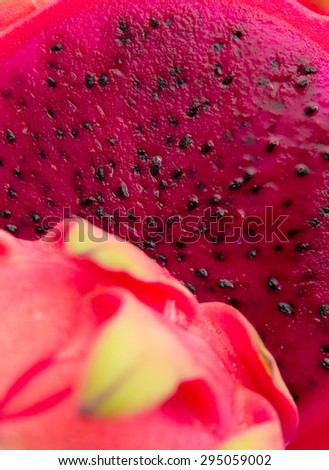 cut red dragon fruit with green scales food background