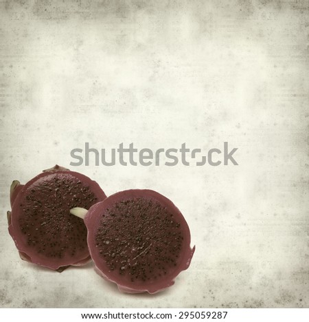 textured old paper background with cut red dragon fruit