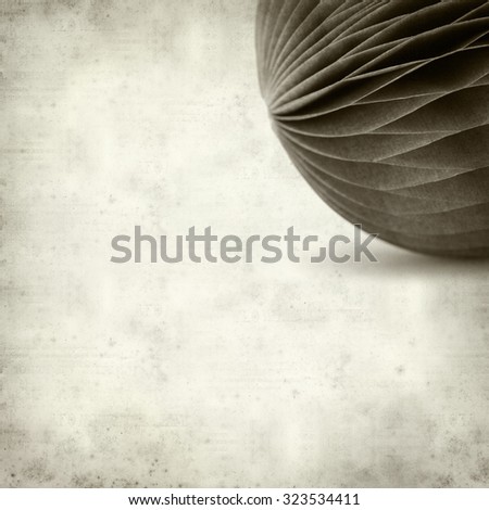 textured old paper background with paper ball ornament