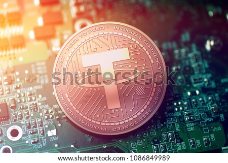 shiny copper TETHER cryptocurrency coin on blurry motherboard background Сток-фото © 
