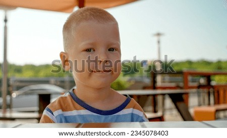 Similar – Foto Bild Kleiner blonder Junge in Winter-Oberbekleidung im Freien