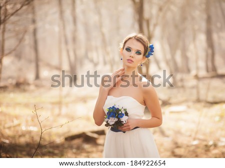 Gentle bride walks in the park