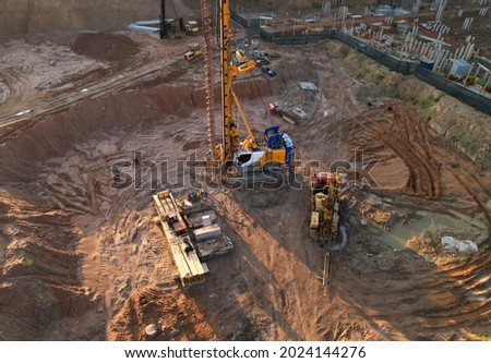 Deep foundation machine. Drilling rig and Pile driver at construction site. Pile driven into ground by vibrating hydraulic hammer. Foundations construction work. Ground drilling and Piling Contractor.