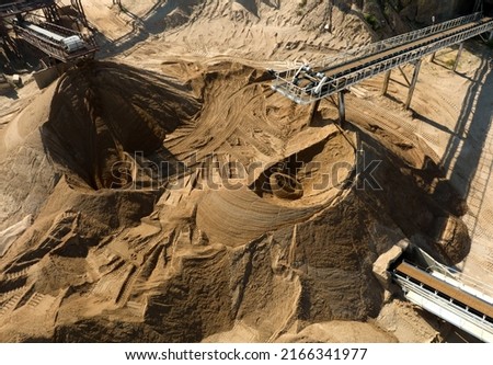 Sand Making Plant and Belt conveyor in mining quarry. Sand crushing and bulk materials for construction. Screening and washing in open-pit mining. Stone jaw crusher plant. Stone crushing plant. Stock foto © 