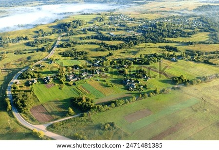 Similar – Image, Stock Photo Foggy travel day, aerial view at the evening traffic at an autumnal country road with lighttrails of driving cars in a beautiful fall atmosphere.