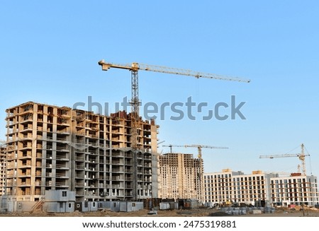 Similar – Image, Stock Photo Skyscraper building construction. Crane working in construction site. Property and real estate development industry. Apartment building construction. Background for REIT fund. Building for rent.