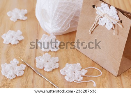 White crochet snowflakes for Christmas decoration of package gift. Selective focus
