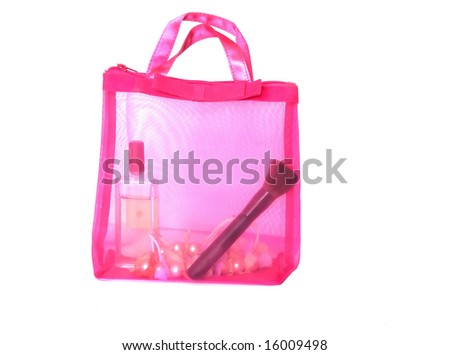 Pink cosmetics bag with cosmetics on white background