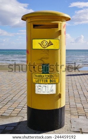LARNACA, CYPRUS --4 JANUARY 2015-- Cyprus Postal Services, the government post operator of Cyprus, has inherited pillar mailboxes from British colonial rule, repainted yellow after independence.