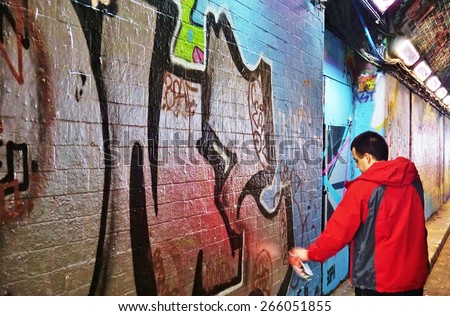 LONDON, ENGLAND -12 MARCH 2015- Editorial: Graffiti street artists are busy at work spray painting walls in the Old Street, Brick Lane and Shoreditch area in East London in the heart of Banglatown.