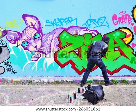 LONDON, ENGLAND -12 MARCH 2015- Editorial: Graffiti street artists are busy at work spray painting walls in the Old Street, Brick Lane and Shoreditch area in East London in the heart of Banglatown.