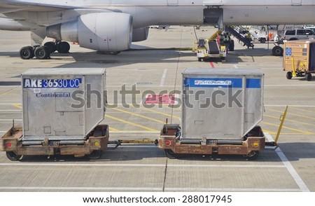 CHICAGO, IL -16 MAY 2015- Baggage containers marked Continental Airlines and United Airlines on the tarmac at Chicago OHare International Airport (ORD). The two companies fully merged in 2012.