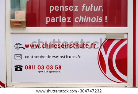 PARIS, FRANCE -8 JULY 2015- A Chinese Institute language learning center in Paris saying on its window Think Future, Speak Chinese (in French).