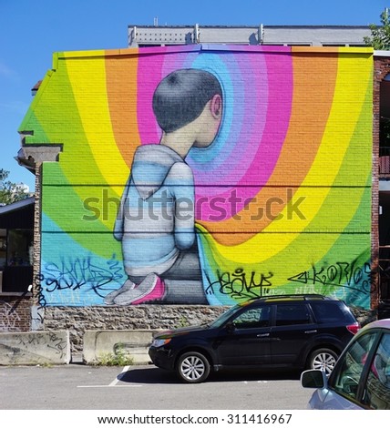 MONTREAL, CANADA -18 AUGUST 2015- Rainbow colored street art wall mural by French graffiti muralist Seth Globepainter in Montreal near Boulevard Saint-Laurent.