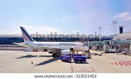 PARIS, FRANCE -8 JUNE 2015- An Airbus A318 plane from Air France (AF),registration F-GUGI, is parked at the gate at the Roissy Charles de Gaulle international airport (CDG).