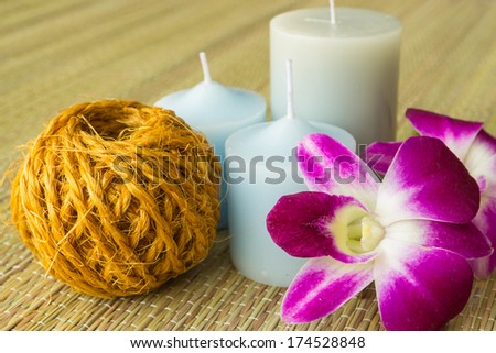 Hemp rope,three candle and  orchid flower on mat for spa
