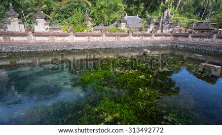 BALI, INDONESIA - 19TH JUNE 2015; People praying in vintage colour at holy spring water temple Puru Tirtha Empul during the religious ceremony  in Tampak Siring, Bali, Indonesia.