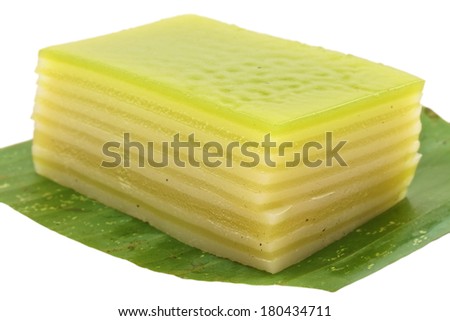 Thai layer cake on a banana leaf green isolated with white background.