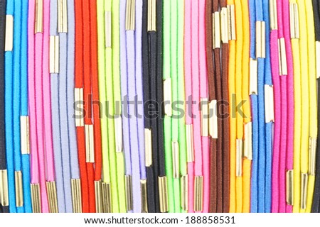 Colorful hair band made from  elastic rubber connect with gold iron place as pattern.