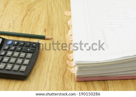 Index document include sales and receipt place with calculator and pencil on wood background.