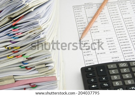 Stack document of account include sales and receipt on finance account with pencil and black calculator.
