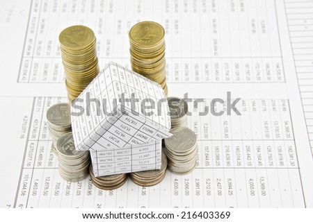 House on pile gold and silver coins place on finance account.
