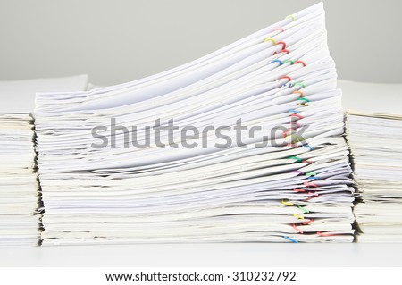 Stack of sales and receipt overload between paperwork place on table.