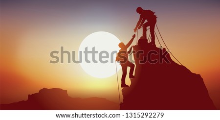 Concept of solidarity, with two mountaineers holding out their hand reaching the top of a mountain, having climbed it successfully