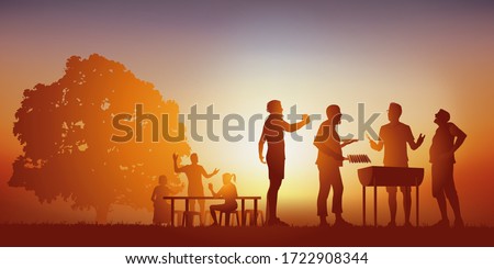 Concept of a moment of conviviality, with a group of friends gathered around a barbecue, to spend a moment of relaxation under the sun of a summer day.